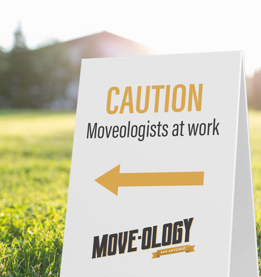 Moveology A-frame caution sign by a field