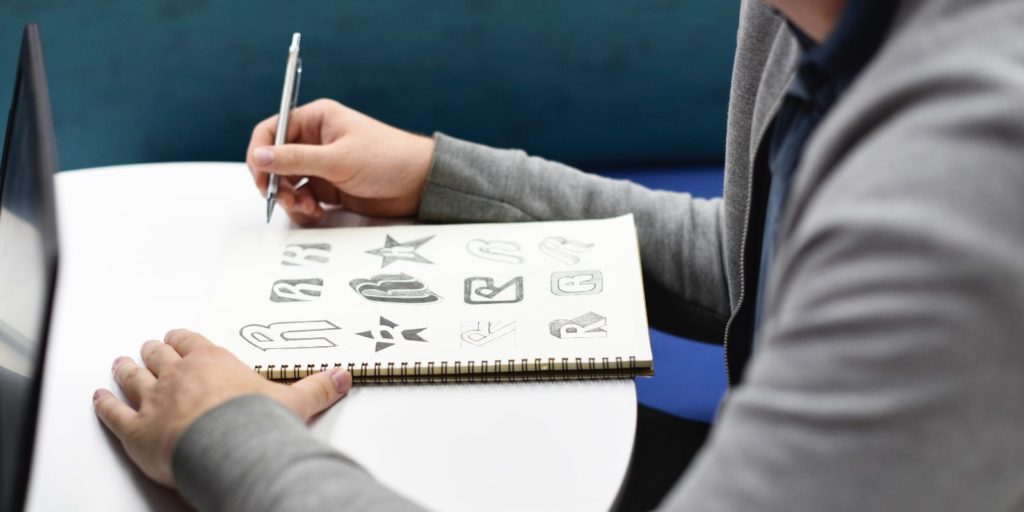 Designer sketching different brand logo ideas