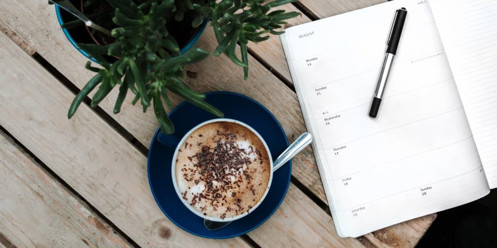 Cup of coffee and a weekly planner